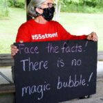 Jeanne Gren holds a sign